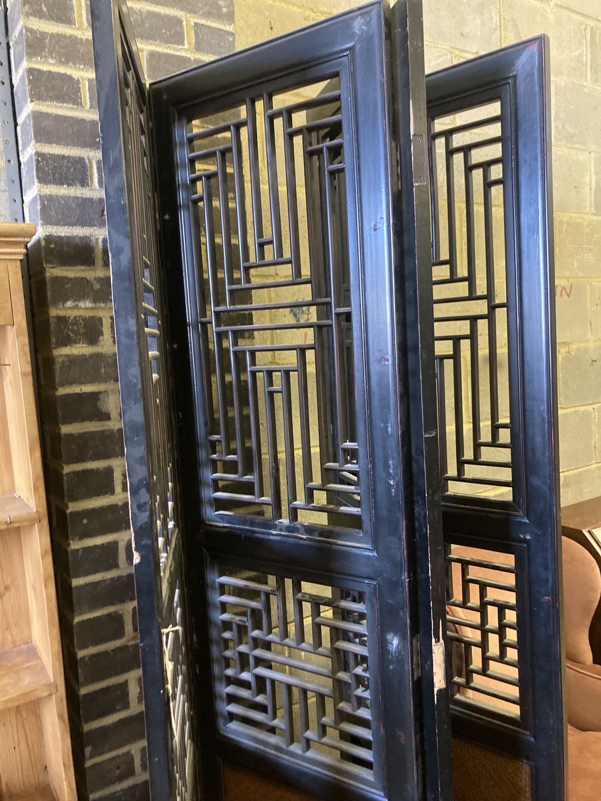 A Chinese hardwood and rattan four-fold decorative screen, each panel width 52cm, height 220cm